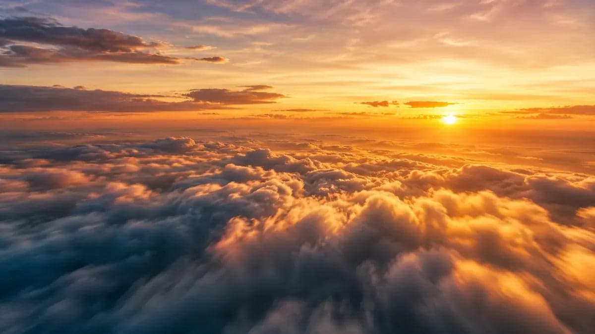 Golden sunrise above a sea of clouds