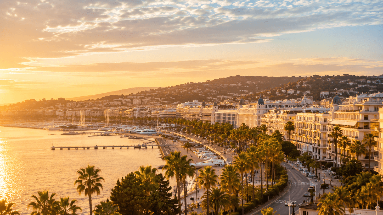 Cannes and the French Riviera at golden hour with La Croisette, marina and palm-lined waterfront