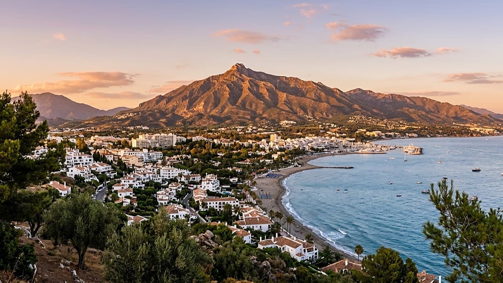Marbella and the Costa del Sol coastline at golden-hour sunset — the private-jet gateway reached via Málaga Airport (AGP)